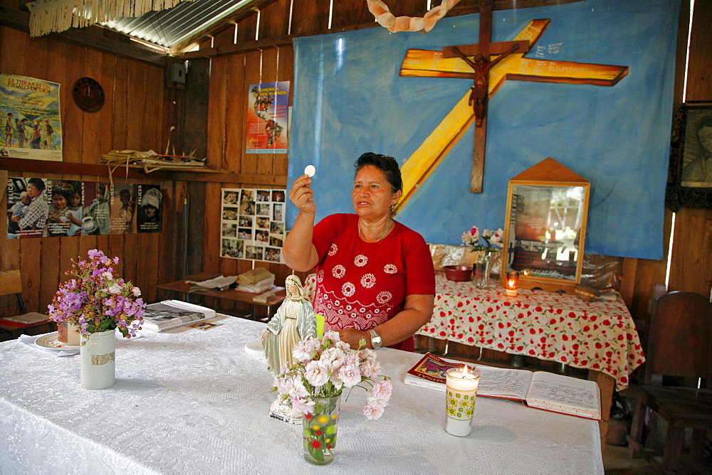 Guatemala santa rita village of returnees, in peten. community fled guatemala during violence of 1980s in times of peace have returned to settle in jungle lowlands. Liturgy of word celebrated at a small catholic chapel in village. Eucharist minister elvira de jesus corado