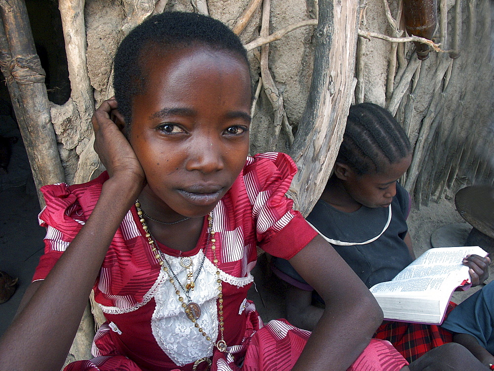 Watatulu tribal children at mwankale , tanzania. - girl on right is reading bible