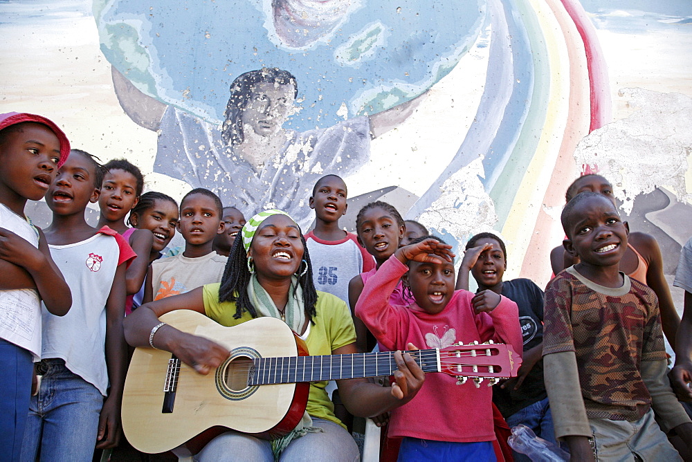 Namibia children, many of whom aids orphans positive themselves at bernard nordkamp (youth) center, katatura, a black township of windhoek, (dating from apartheid). Singing christian songs with a theme of protecting children against abuse, pregnancy, aids raising their spirits