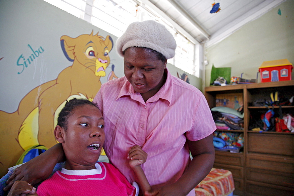 Namibia oranganda community centre, windhoek. A place which looks after children with severe disabilities. Director of centre with an 18-year- girl with ms. maryknoll