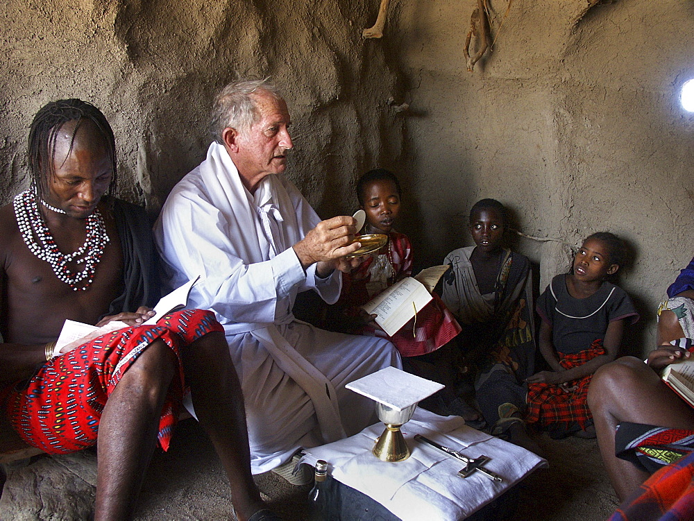 Watatulu tribals at catholic mass, tanzania. - with father dan ohman in a hut at mwankale