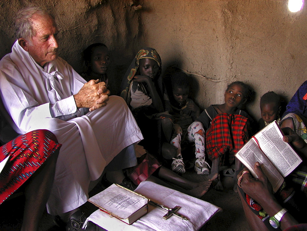 Watatulu tribals at catholic mass, tanzania. - with father dan ohman in a hut at mwankale