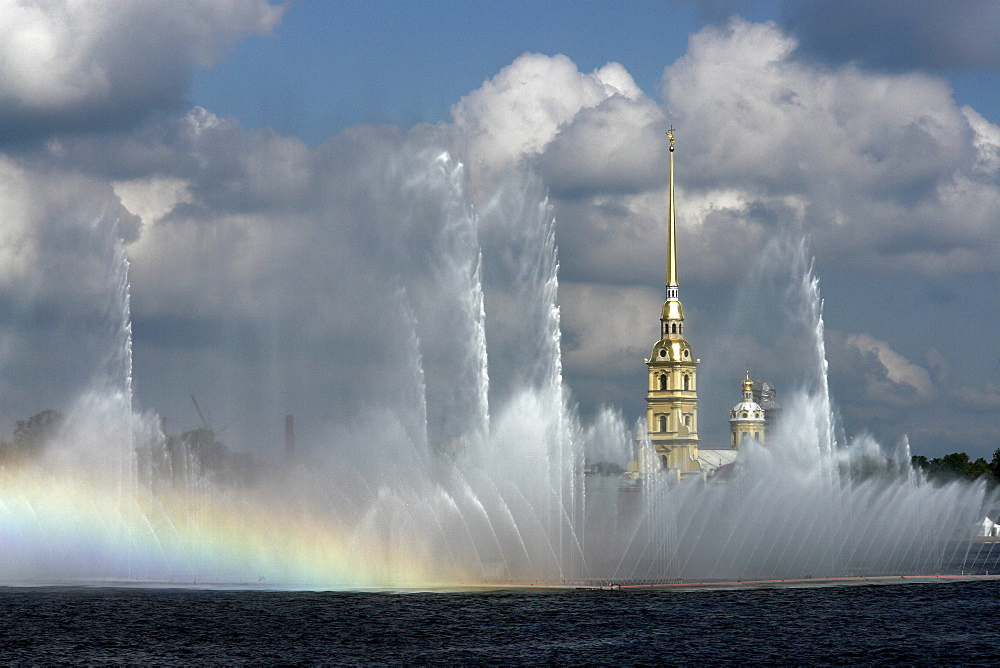 Russia view across river neva towards peter paul fortressm through fountain display which floats on river. Saint petersbur