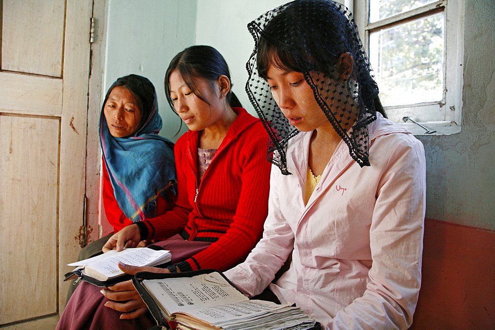 Myanmar sunday mass in catholic church at myitkyina, a largely kachin, catholic, community in north burma near chinese border. Girls singing hymns 