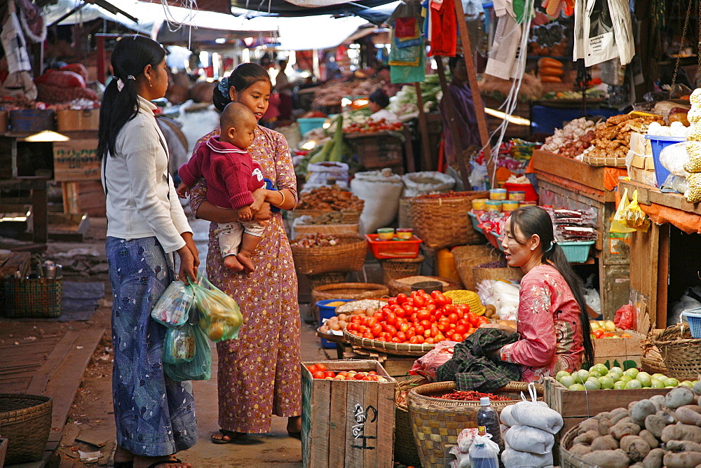 Myanmar vegetable seller (baby) in market at myitkyina, a largely kachin community in north burma near chinese border 