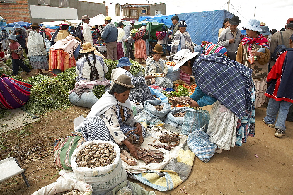 Bolivia. Aymara women selling potatoes and other vegetables at a street market in el alto