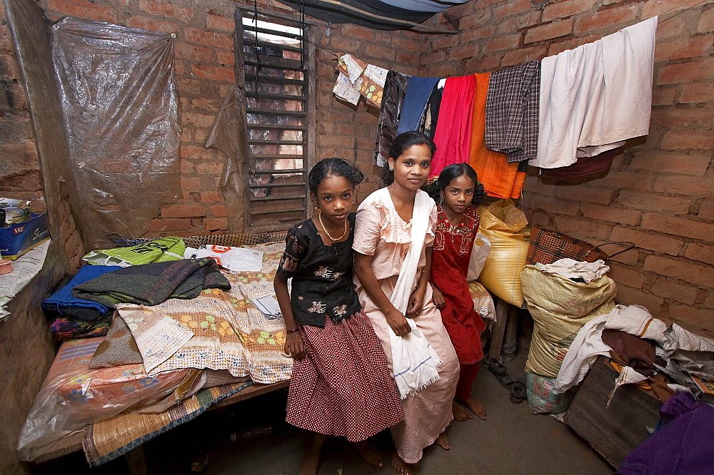 India. Small home of hindu family, omana radhara krishnan (mother) and her daughters rashmi (14) and maya (11). They will soon get a better house thanks to house building project funded by cnewa and implemented by diocese of kottayam social services in villages of wayanad district, kerala. 2007   