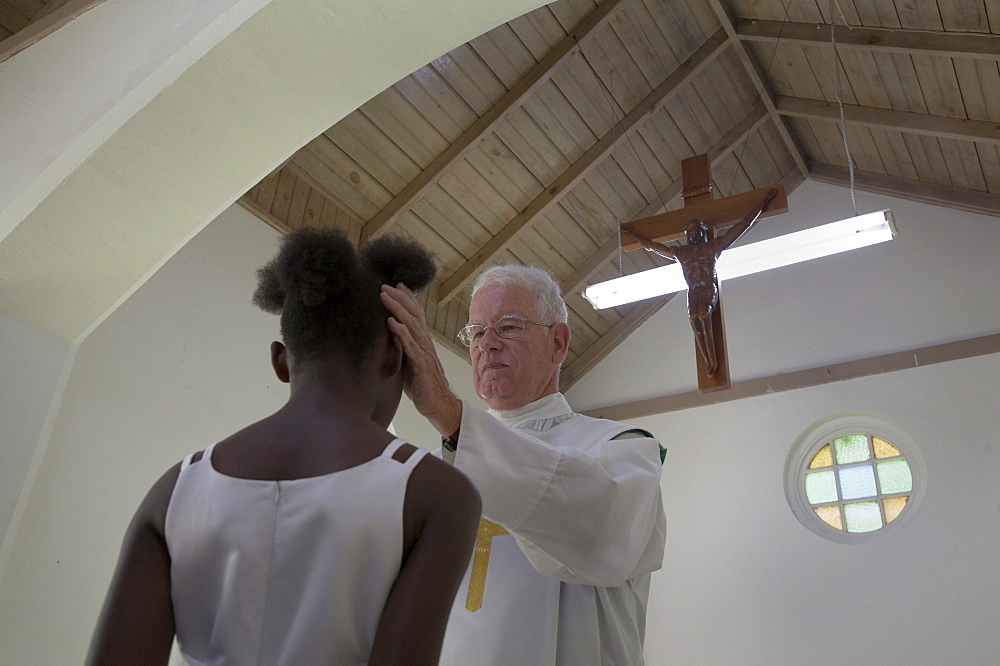 Jamaica. American priest celebrating sunday mass at catholic church in chester castle