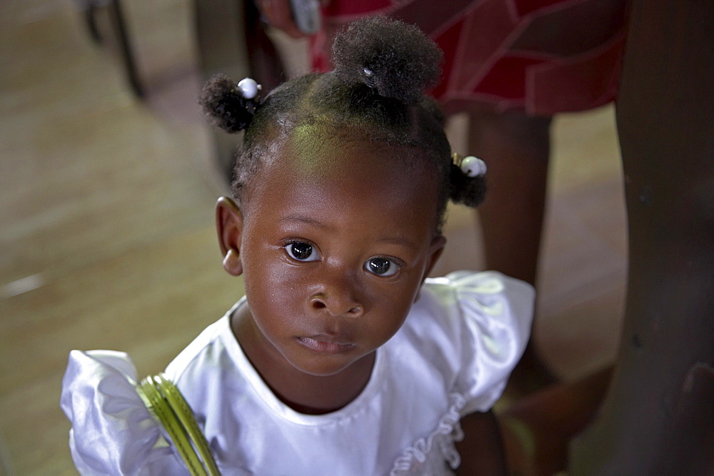 Jamaica. Girl at sunday mass in the catholic church at seaford town