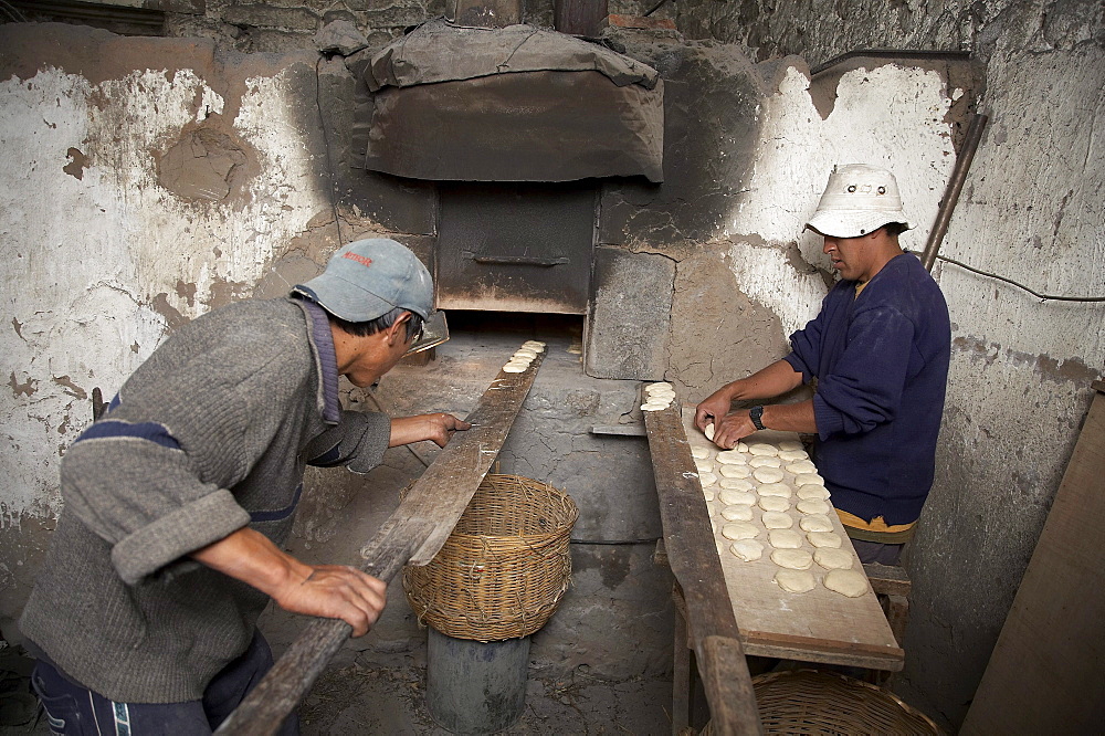 Peru. Making bread on wood fired oven, colca canyon