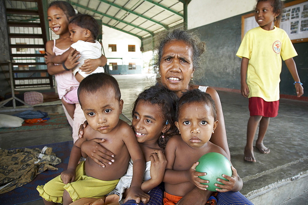 East timor. Camp for internally displaced people (idps) at the don bosco center in dili. Woman with her children