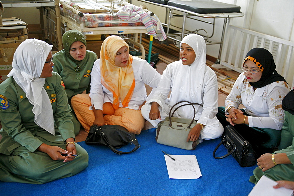 Indonesia government health clinic (pos kesmas) at cot seumereng, desa pucoh leung. training session for health workers. they are discussing strategy for immunisation. activity supported by crs. meulaboh, aceh