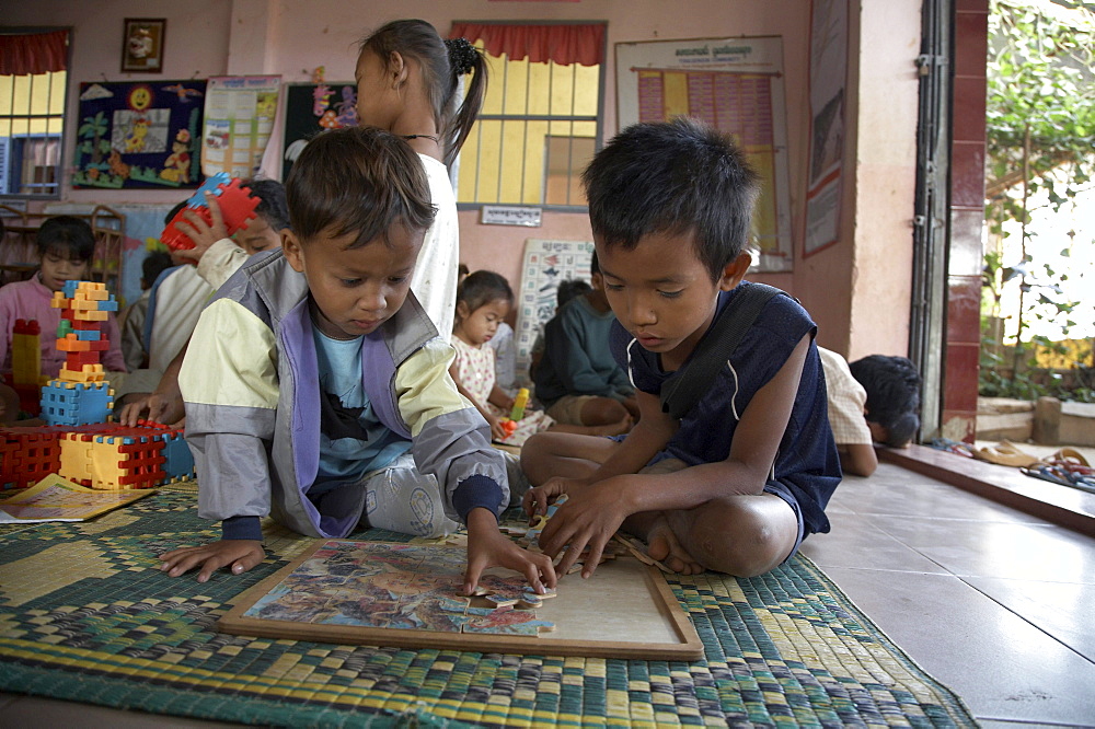 Cambodia childrens center at anlon kgnan. young children playing with toys