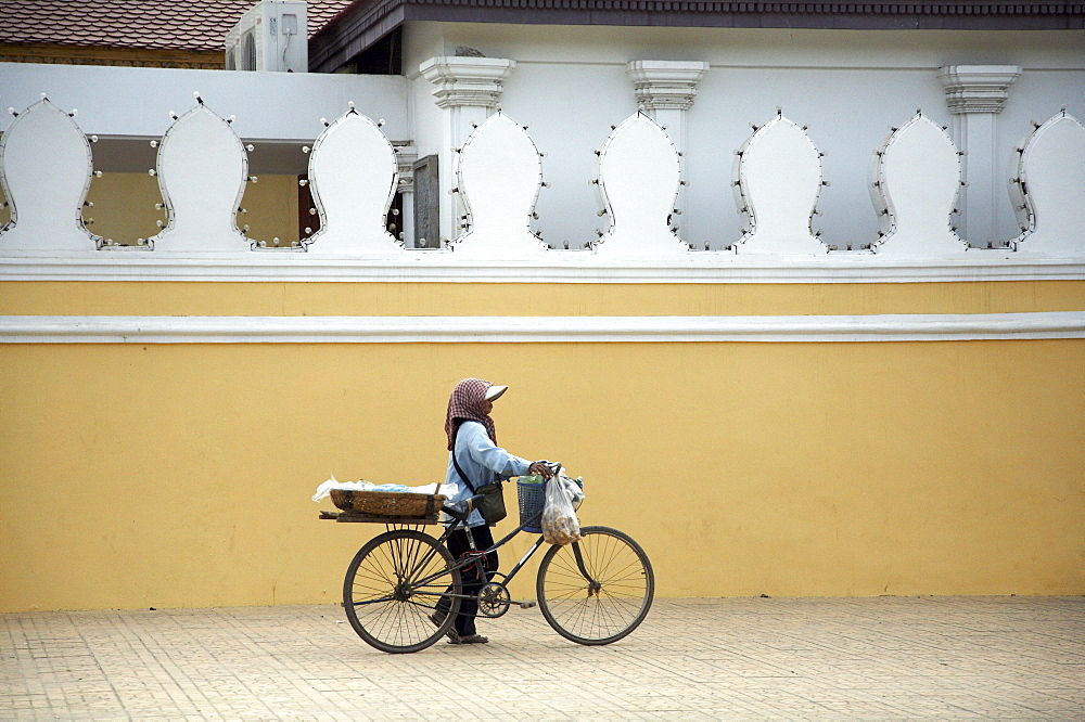 Cambodia woman with bicycle from which she sells snacks as a business. phnom penh