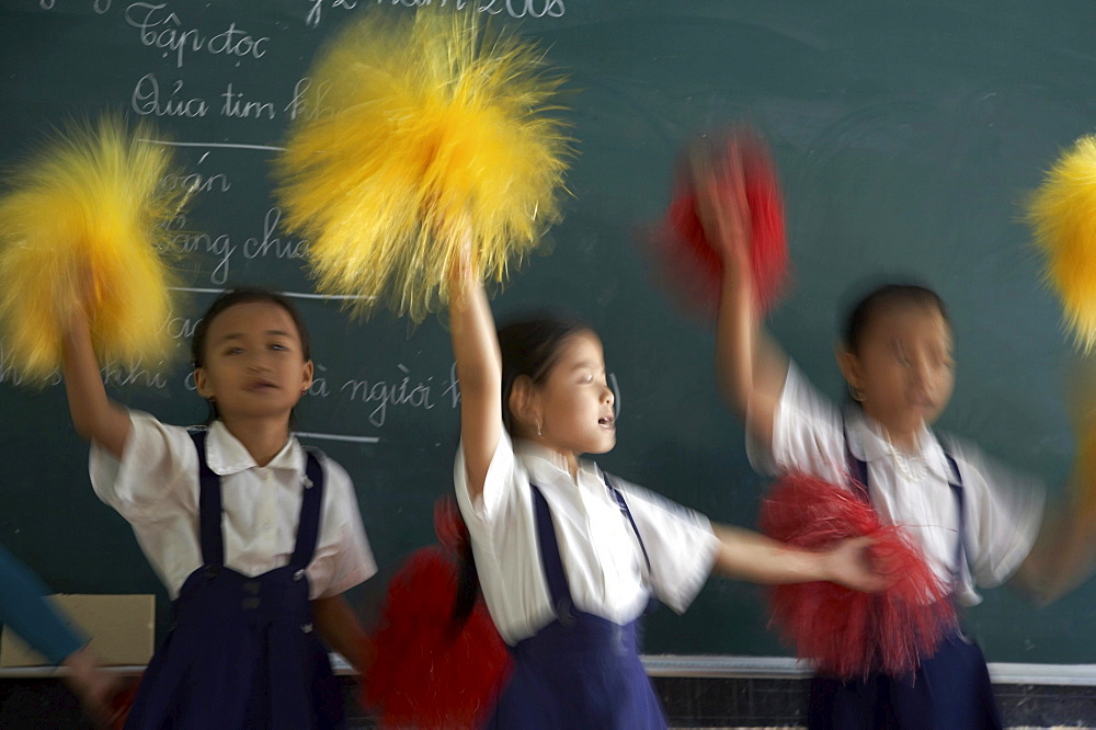 Vietnam hoa binh primary school in vinh long province. children in school practice cheerleading