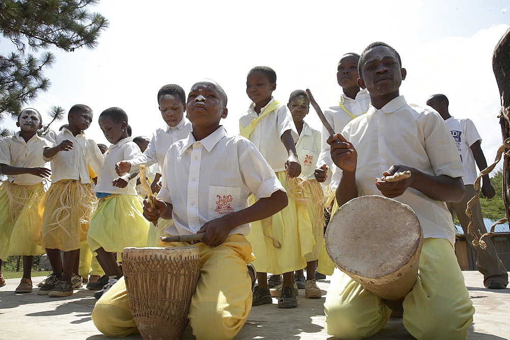 Tanzania school children dancing and playing drums on world aids day, kalabezo