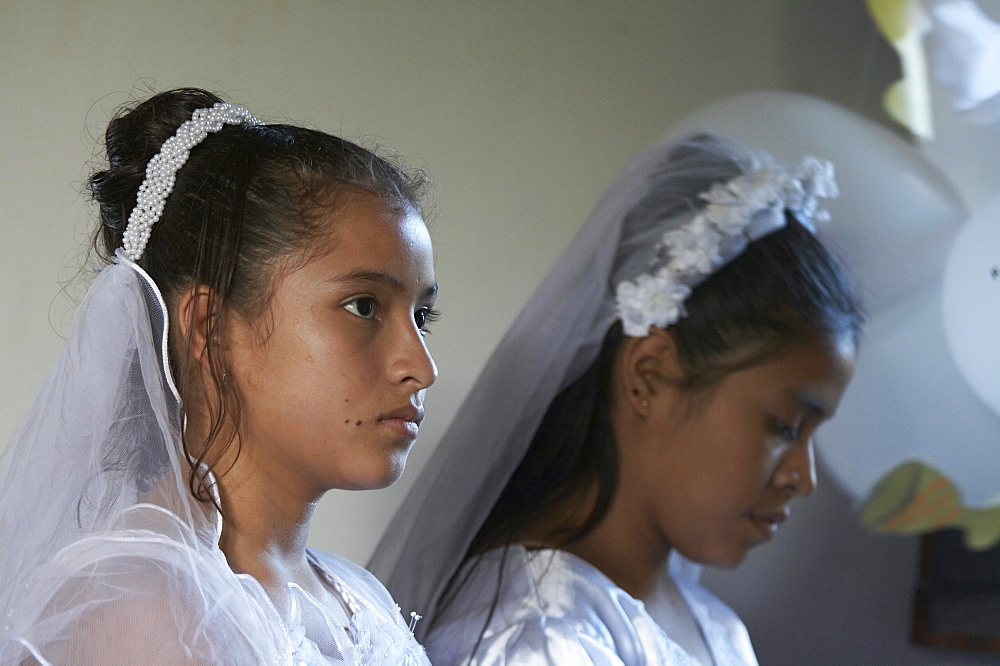 Guatemala catholic first communion and mass at remate, el peten. girls during mass