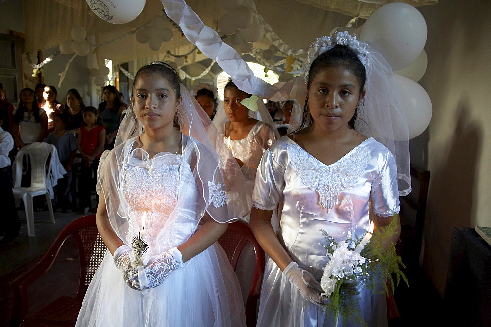 Guatemala catholic first communion and mass at remate, el peten. girls during mass