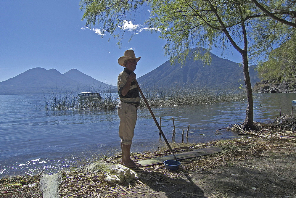 Guatemala man cleaning garbage from beach, san marcos la laguna, lake atitlan.cdref0754