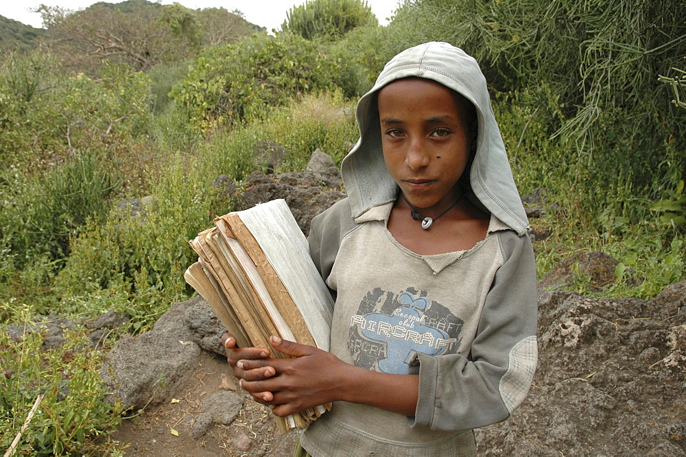 Child, ethiopia. Tullo gudo island and its monastery of debre zion, lake ziway. Girl walking to school carrying her books