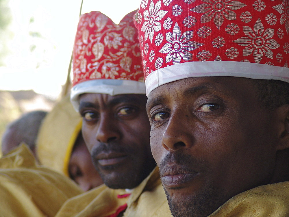 Religion, ethiopia. Debre zeyit orthodox church, kuifto village. Deacons of the church dressed in yellow robes and red or yellow caps, on attendance during sunday mass