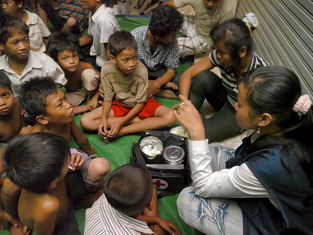 CAMBODI A Children receiving first aid by an outreach team of CSARO, central Phnom Penh