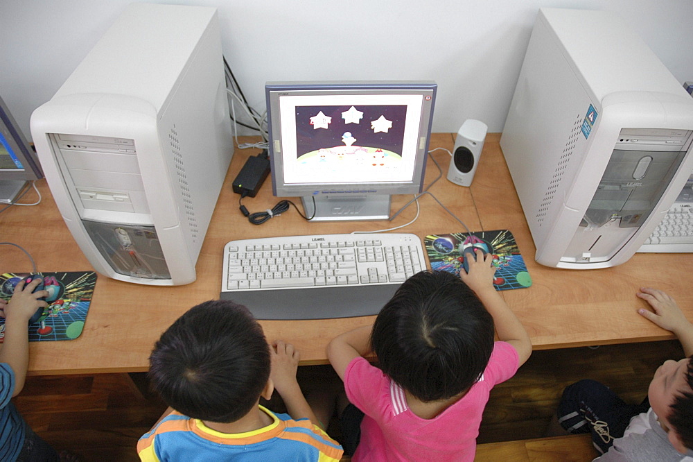 Education, taiwan. Children at a day care center in taichung, using computers