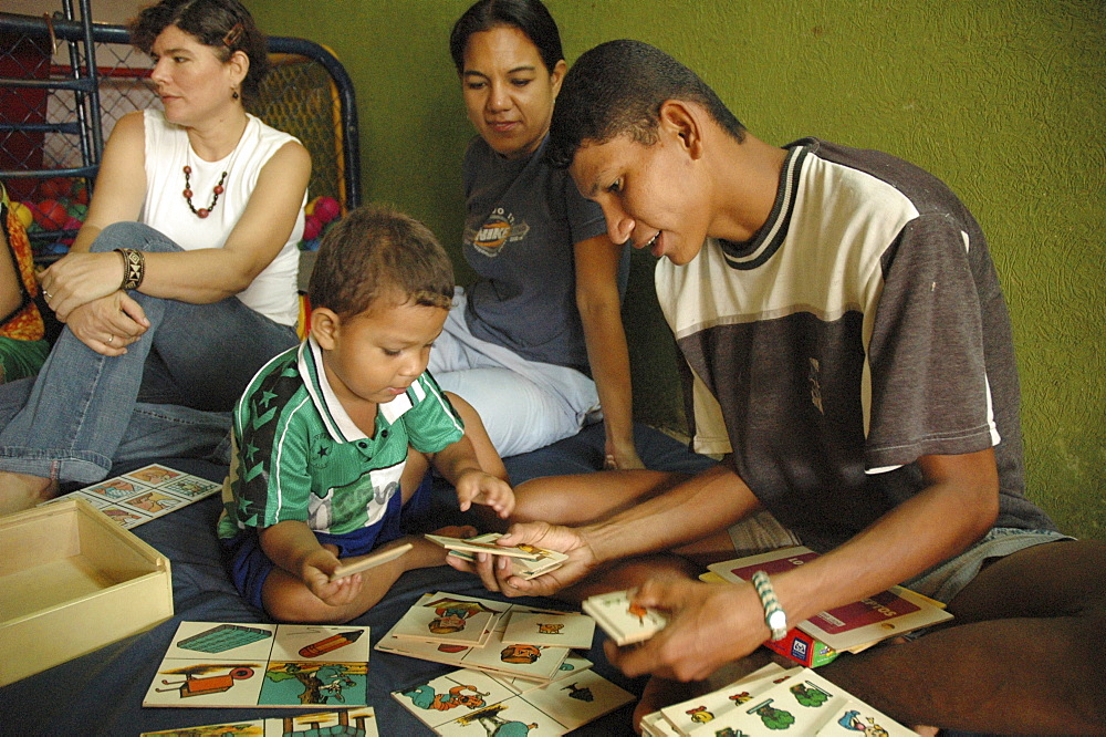 Colombia father relating nicely to his son at a day care and child stimulation center run by dni (international defence of children) in barrancabermeja