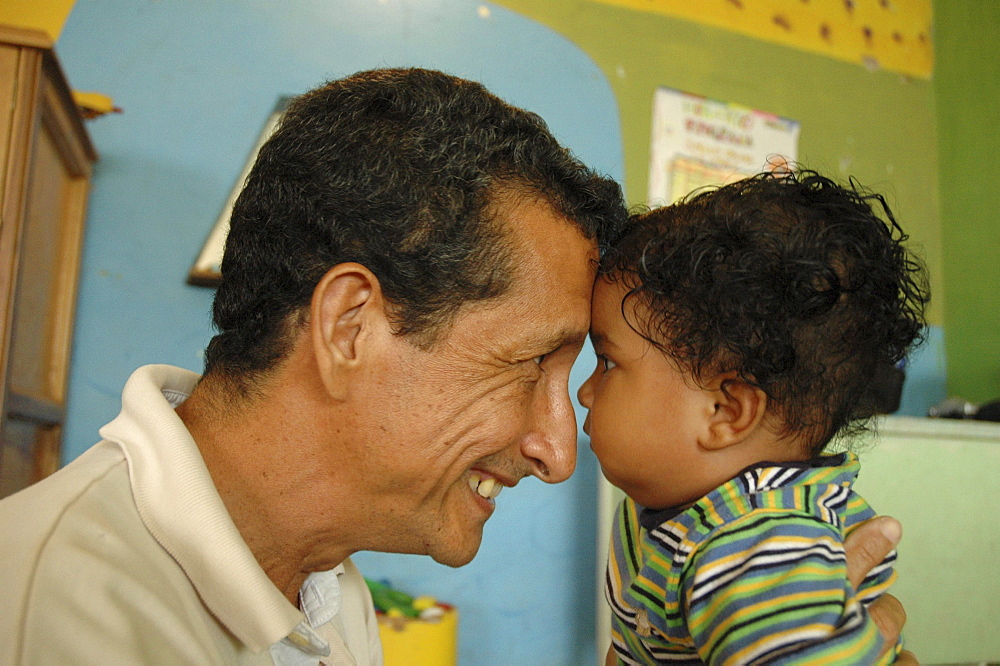 Colombia father relating nicely to his son at a day care and child stimulation center run by dni (international defence of children) in barrancabermeja