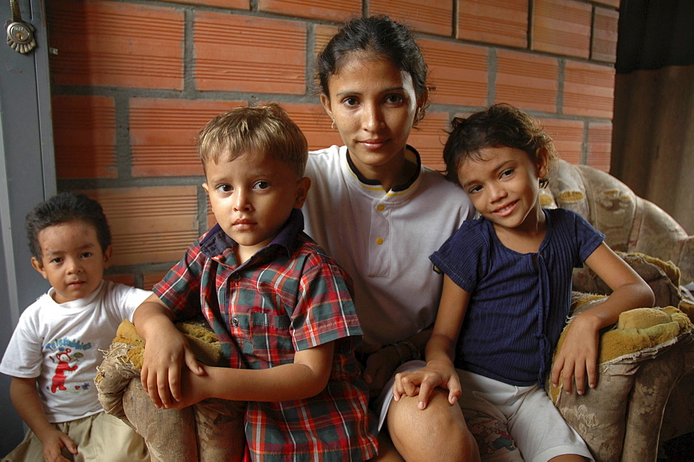 Colombia single mother with her children, barrancabermeja. Beautiful people, but they are extremely poor, and the children both suffer from malnutrition and stunted growth. She often does not send them to school becasue they are too hungry