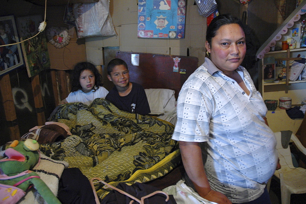 Colombia woman and her children at home in altos de cazuca, bogota