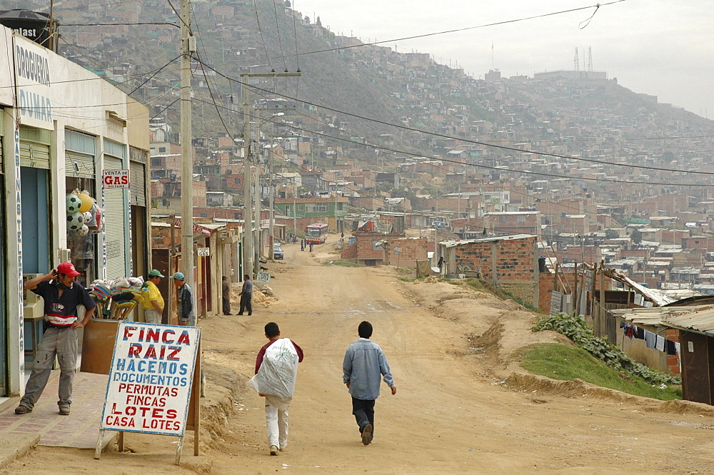 Colombia dirt road and sprawling slum development at altos de cazuca, bogota