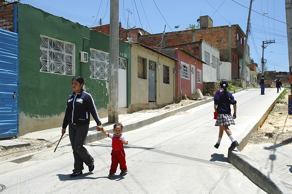 Colombia girls walking home from school in ciudad bolivar, bogota