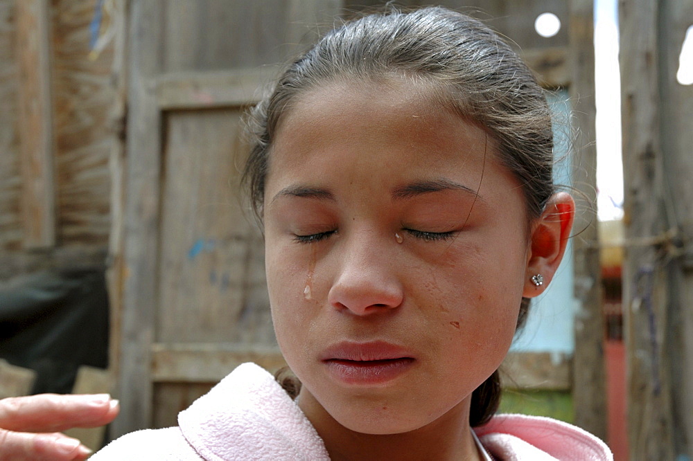 Colombia girl crying as she tells the story about how her father was murdered by paramilitaries as she watched