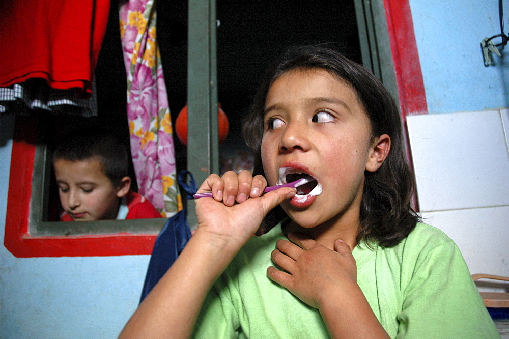 Colombia marly juliet, 7, of the slum of altos de cazuca, bogota, brushing her teeth