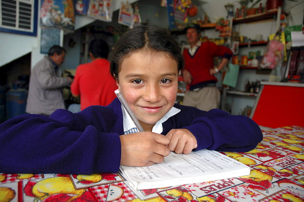 Colombia marly juliet, 7, of the slum of altos de cazuca, bogota, doing her homework