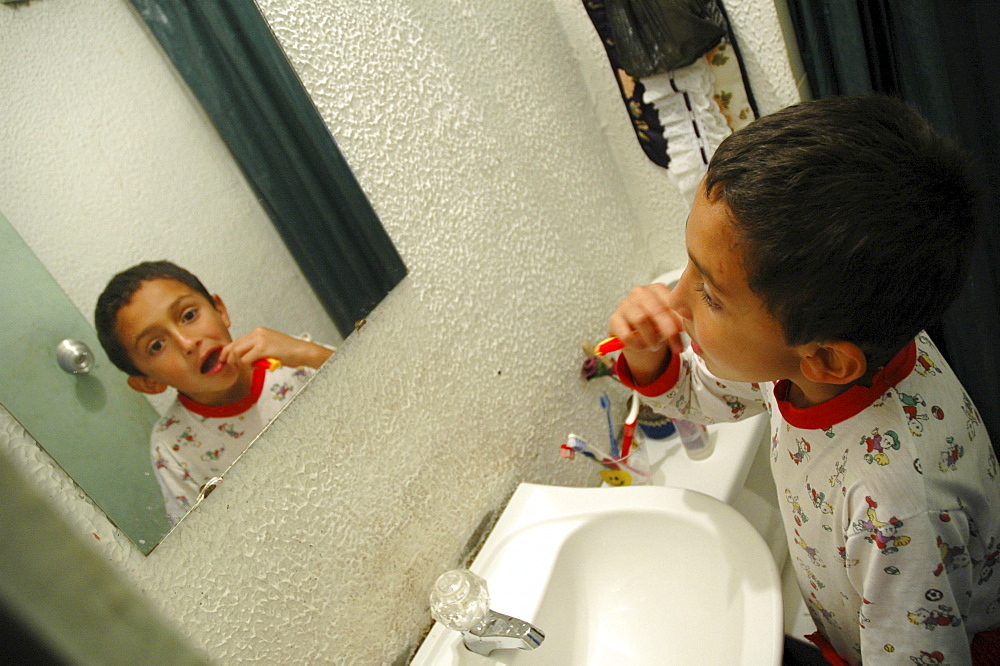 Colombia day in the life series: hugo andres, 7, of ciudad bolivar, bogota, brushing his teeth.