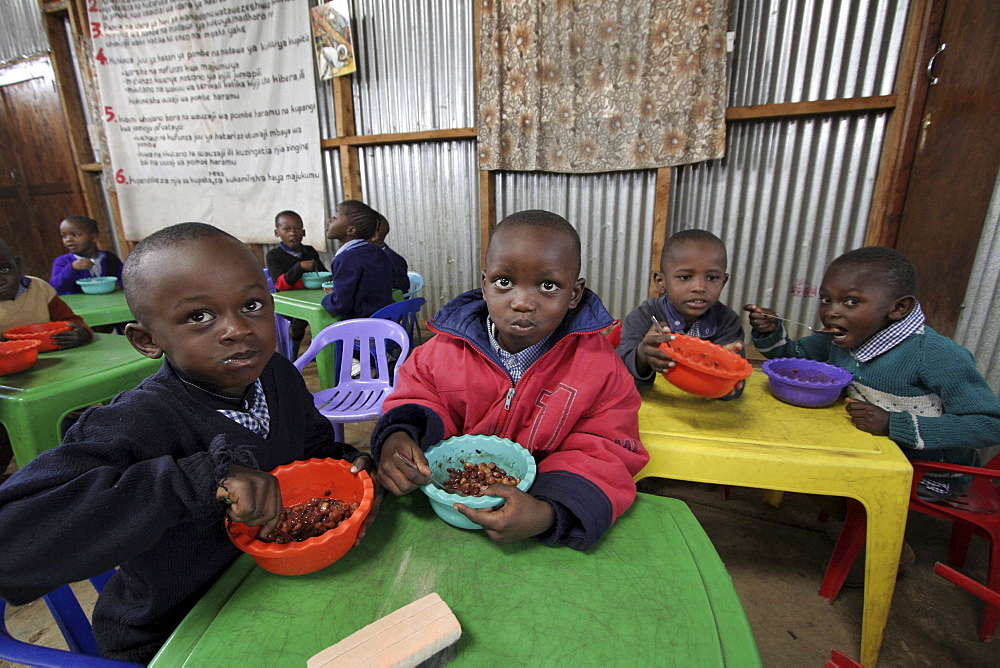 Kenya day care center in kibera slum, nairobi. Meal time at the center