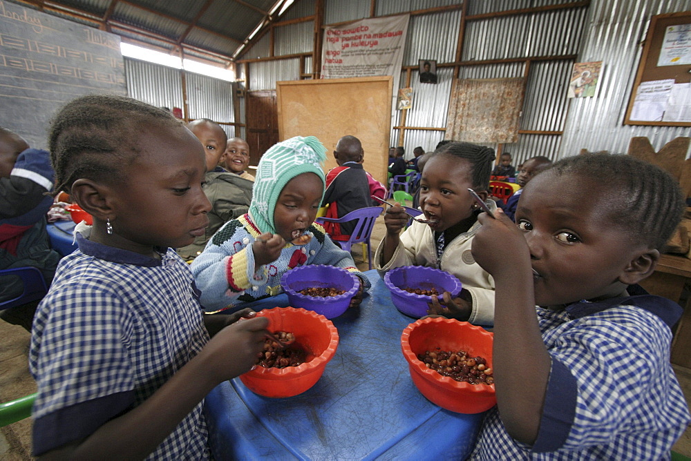 Kenya day care center in kibera slum, nairobi. Meal time at the center