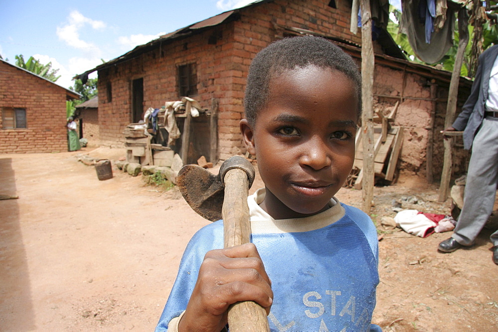 Tanzanian boy carrying a hoe. Kighare, same, in the north-east near kilimanjaro