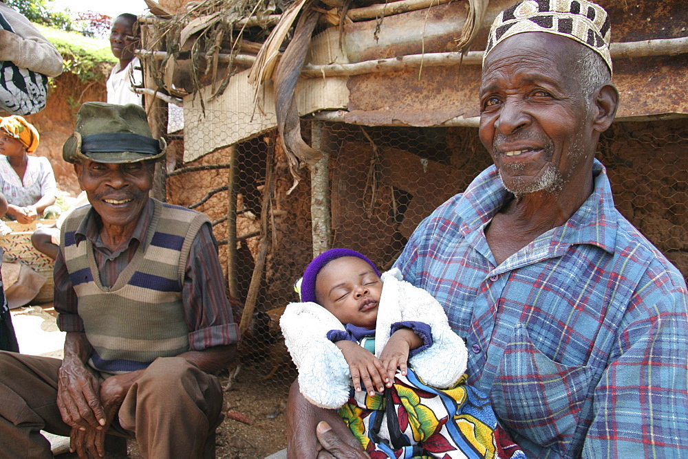 Tanzanian muslim man with grandchild, of mvango village, same, in the north-east near kilimanjaro