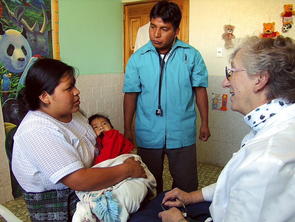 Guatemala nurse liz remily (right) attending to patients at her clinic in santa clara la laguna