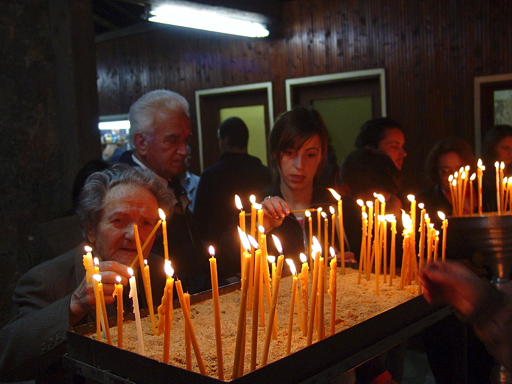 Macedonia (the former yugoslav republic of macedonia, fyrm) worshippers with candles at saint clement orthodox church, ohrid, on easter saturday night