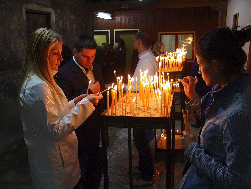 Macedonia (the former yugoslav republic of macedonia, fyrm) worshippers with candles at saint clement orthodox church, ohrid, on easter saturday night