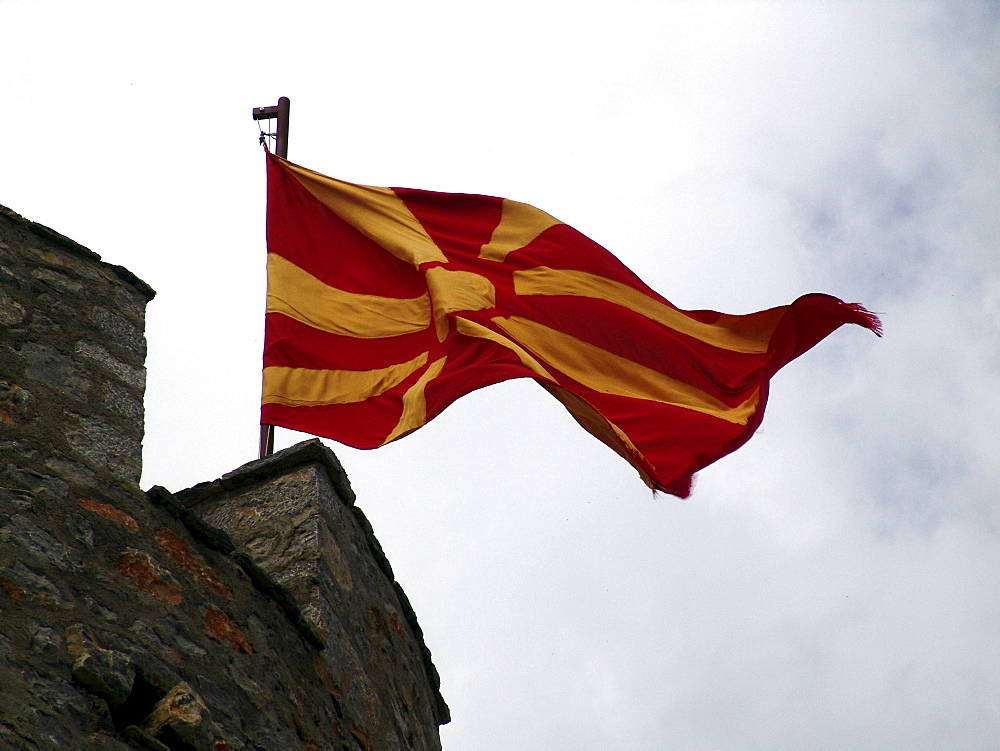 Macedonia (the former yugoslav republic of macedonia, fyrm) national flag flying from castle. The town of ohrid on the shore of lake ohrid