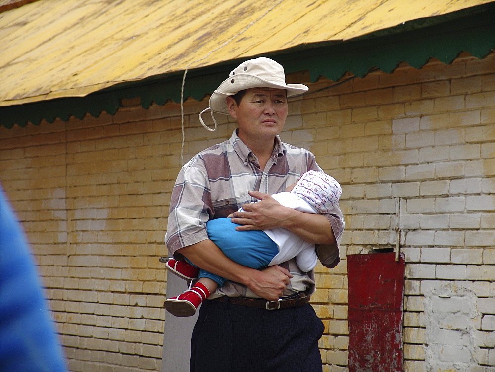 Mongolia man with baby, gandan monastery, ulaan baatur