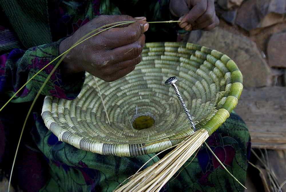 Women working at traditional basket. Most of the furniture in the houses are made out of natural element like sisal,wood or mud. Ethiopia