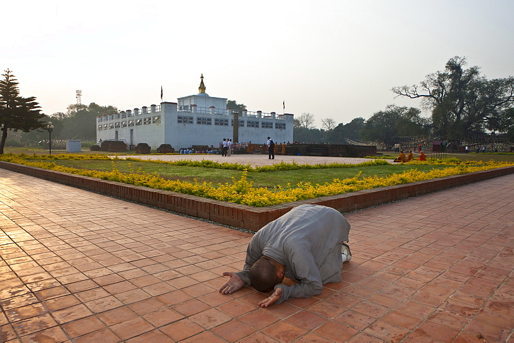 Buddhist monk make prostration as he circumambulate the mayadevi temple in lumbini. Nepal