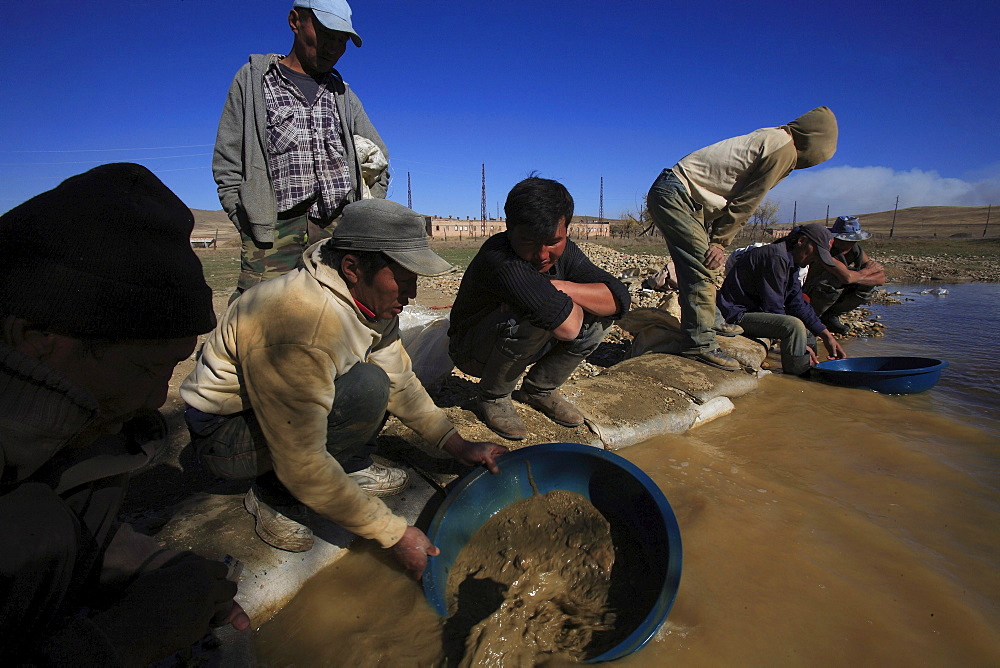 Gold rush,ninjas precious metal in a river in sarangol valley, northwest of capital city ulan bator, mongolia. Ninjas named green pans they wear on their backs that make them resemble cartoon ninja turtle