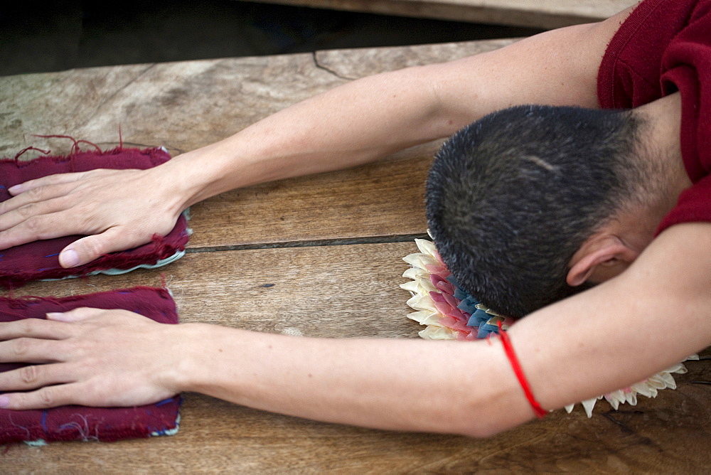 Monk prostrating in front of maha bodhi temple. Bodhgaya prostration is a gesture used in buddhist practice to show reverence to the triple gem (comprising the buddha, his teachings, and the spiritual community) and other objects of veneration. Kalachakra initiation in bodhgaya, india  